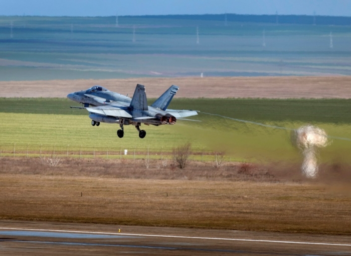 A Royal Canadian Air Force CF-188 Hornet aircraft heads home after being deployed to Operation REASSURANCE–Air Task Force Romani