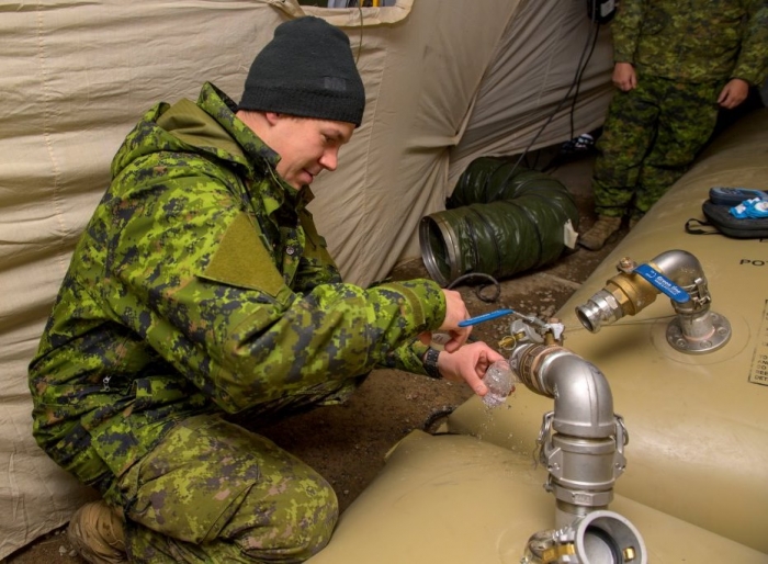 Master Sailor Matthew Skinner collects water samples for daily testing during Operation LENTUS credit: Master Corporal Jax Kenne